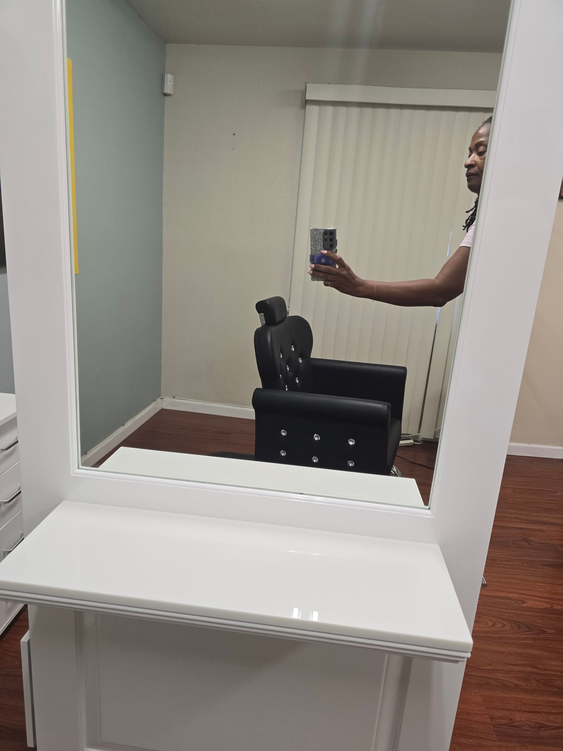 Woman is taking a selfie in front of a mirror in a room