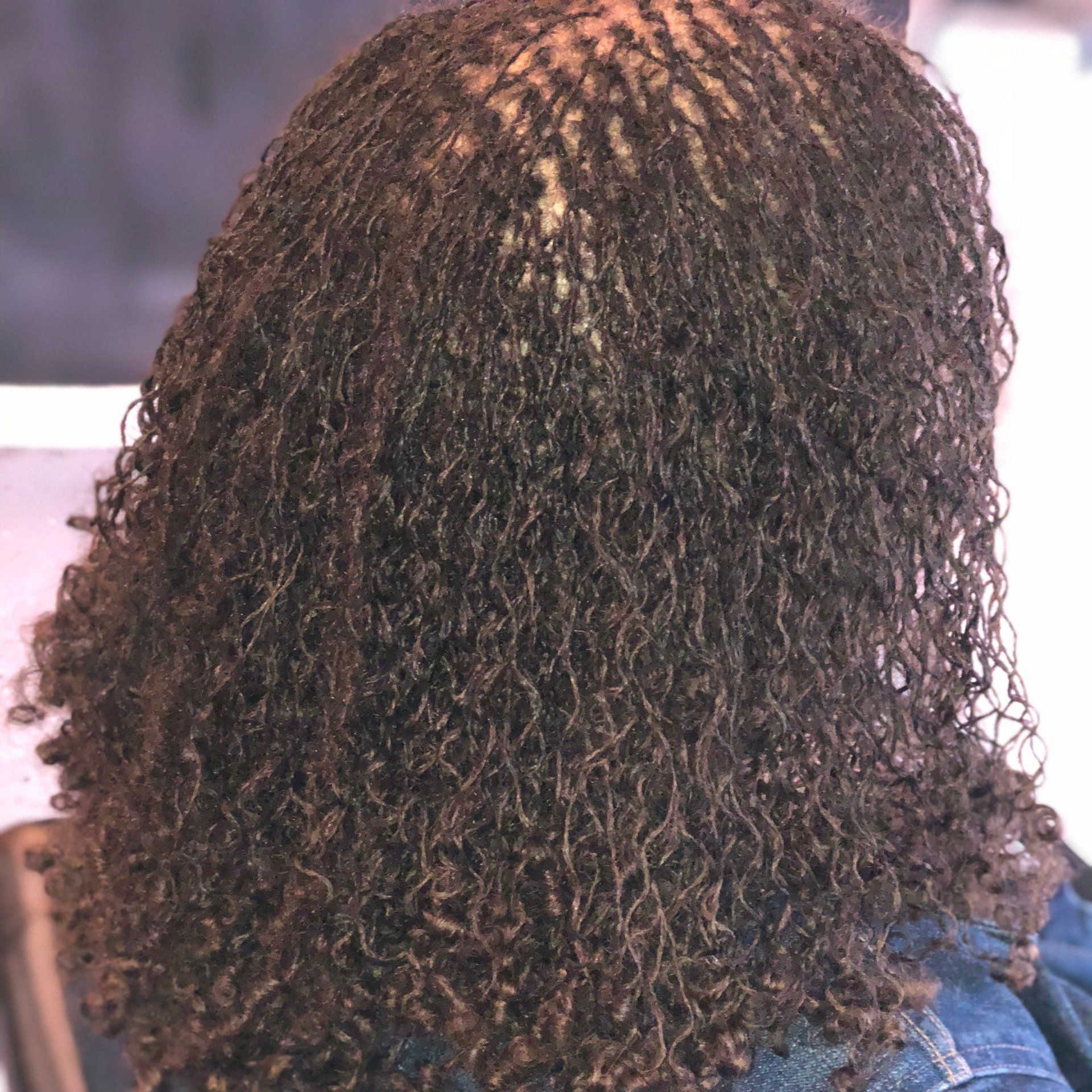 A close up of a woman 's hair with dreadlocks