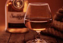Glass of cognac and a bottle