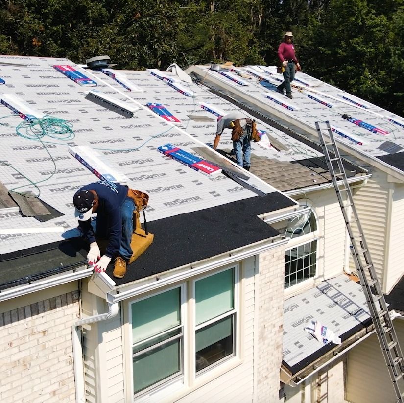 Two men are working on the roof of a house