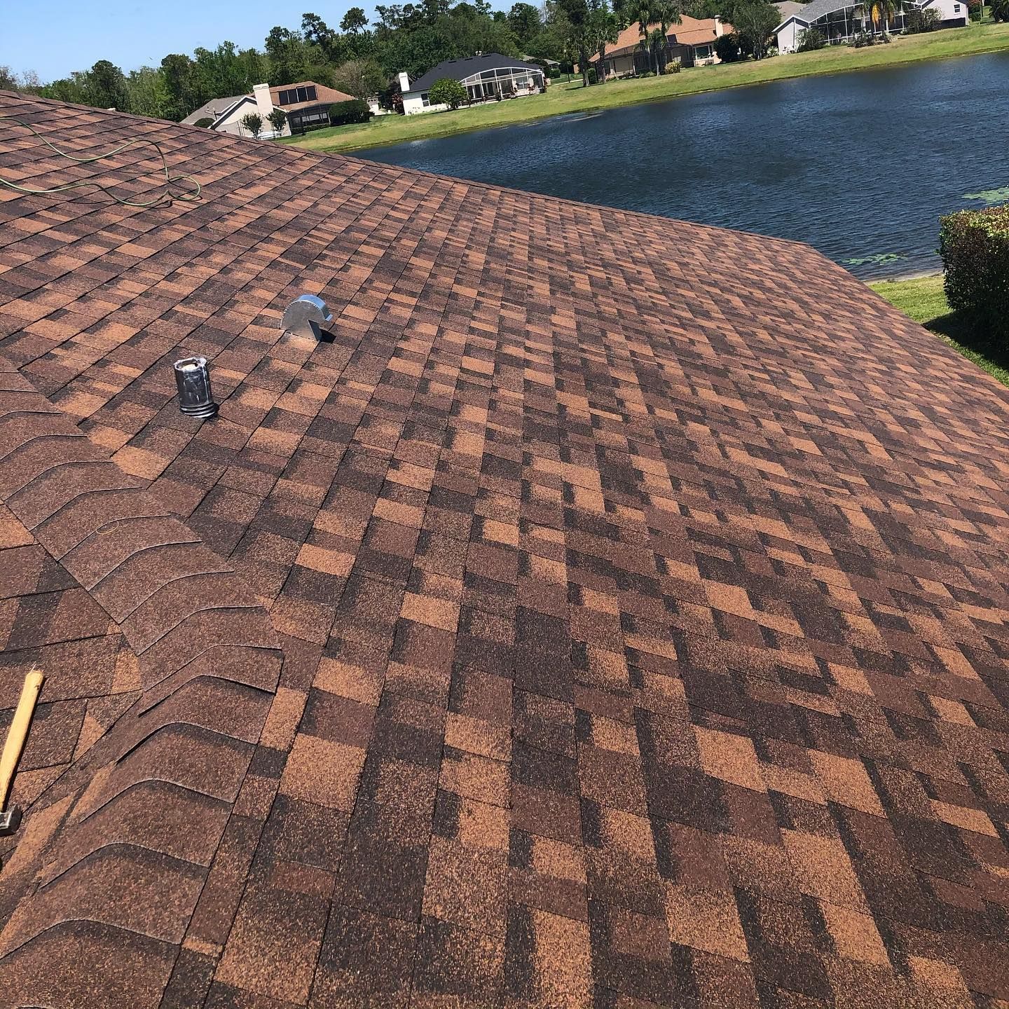 A close up of a roof with a lake in the background