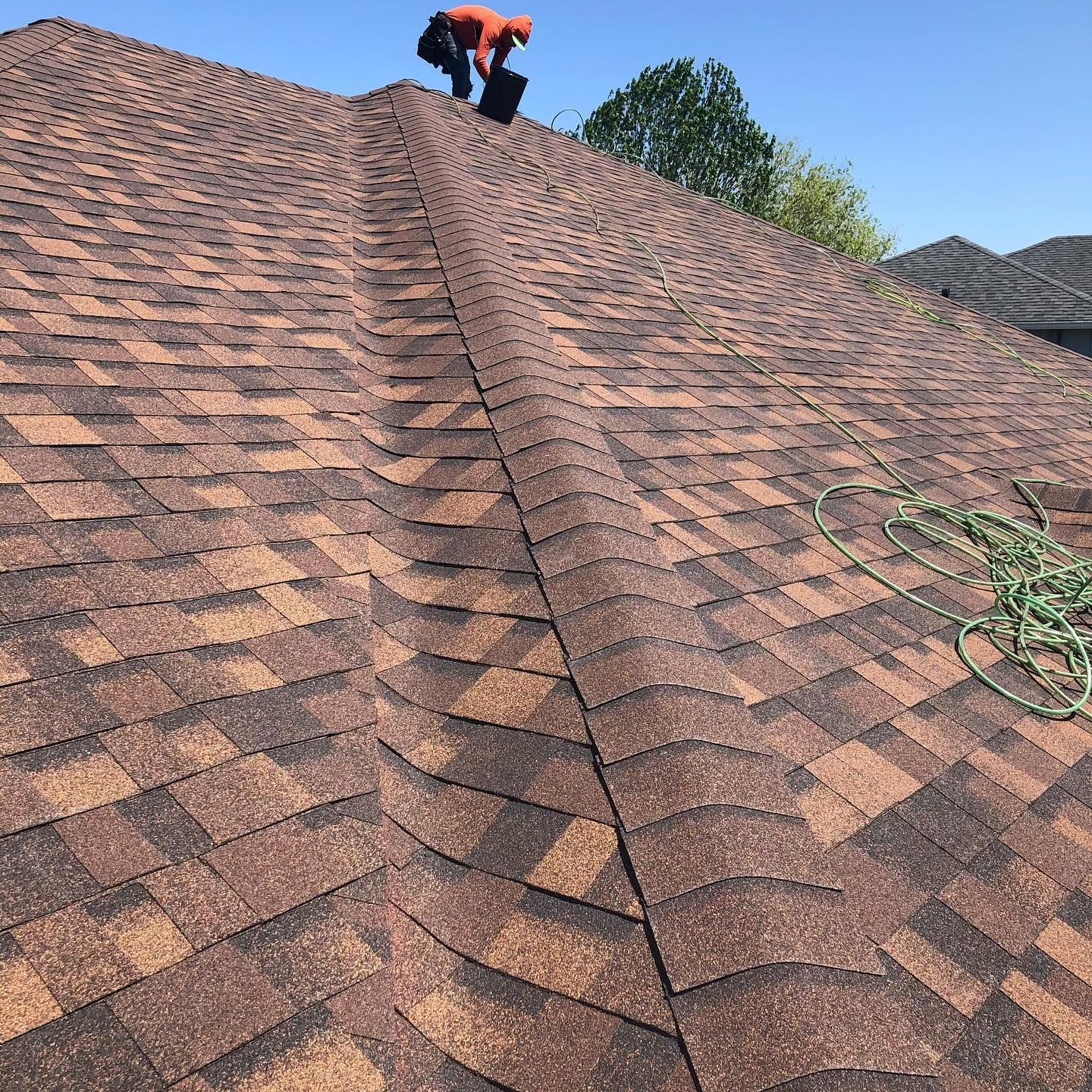 A man is working on the roof of a house