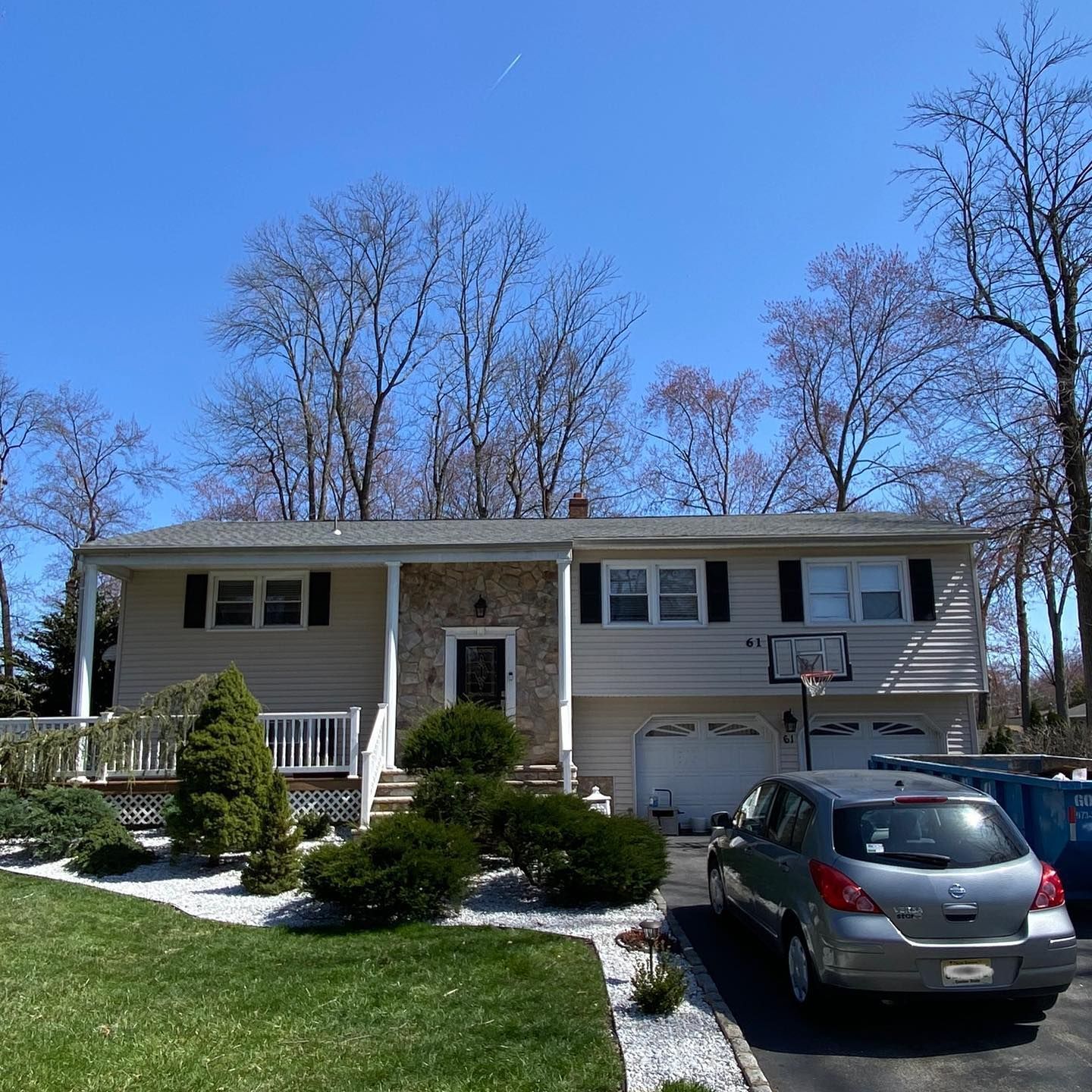 A house with a car parked in front of it