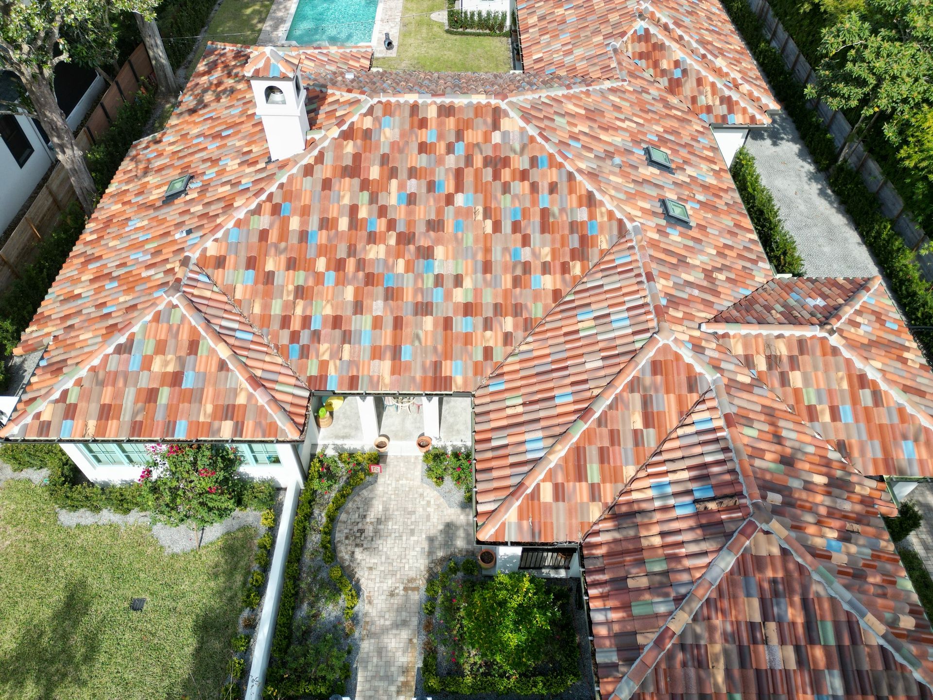 An aerial view of a large house with a tiled roof