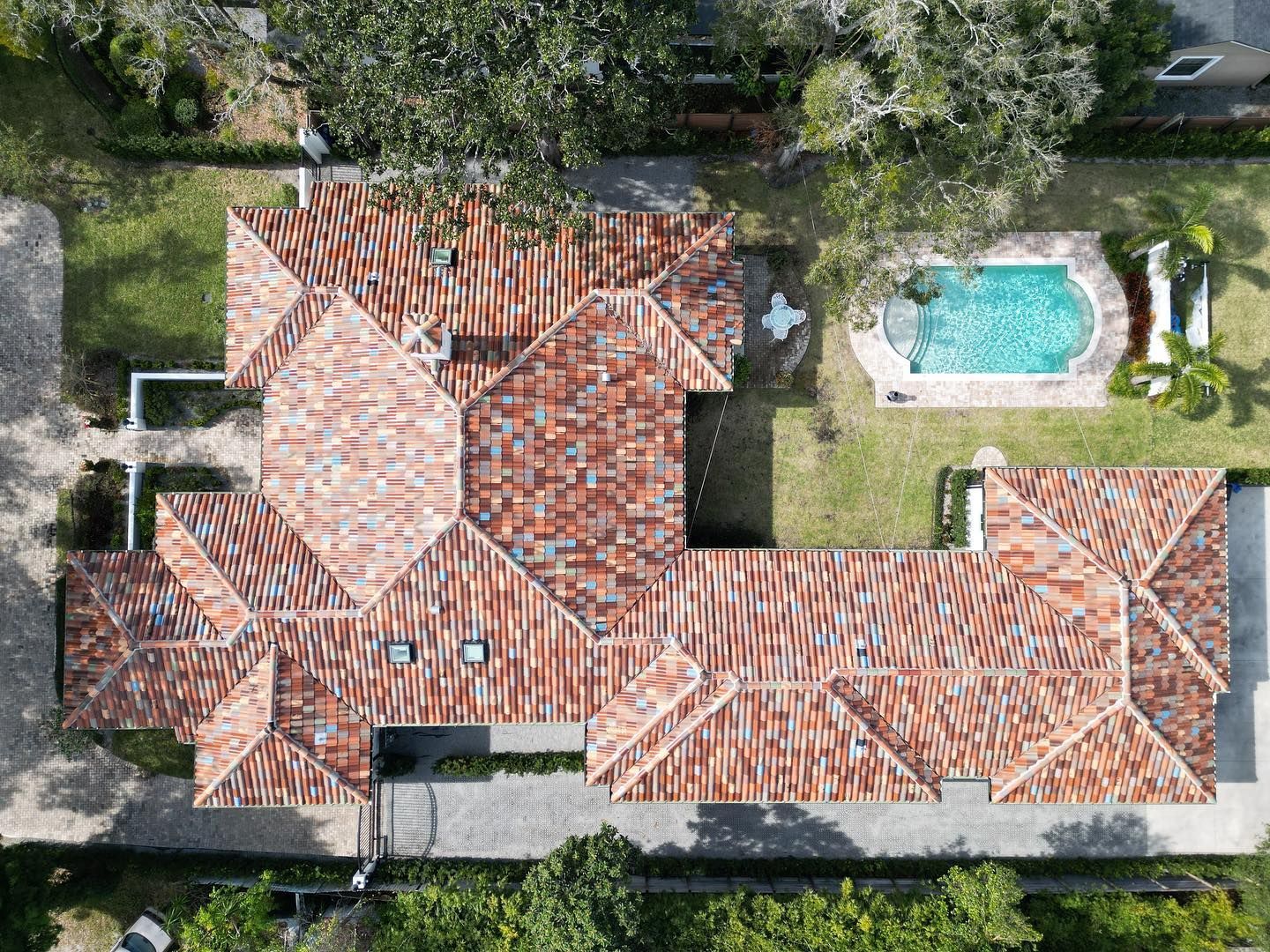 An aerial view of a house with a pool in the backyard