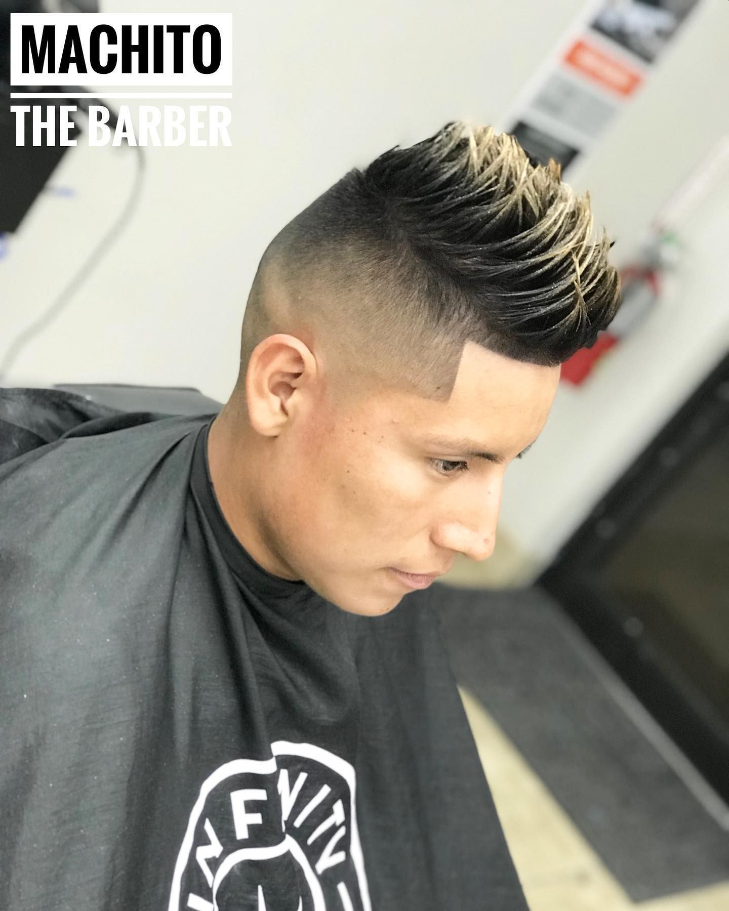 A man is getting his hair cut at machito the barber