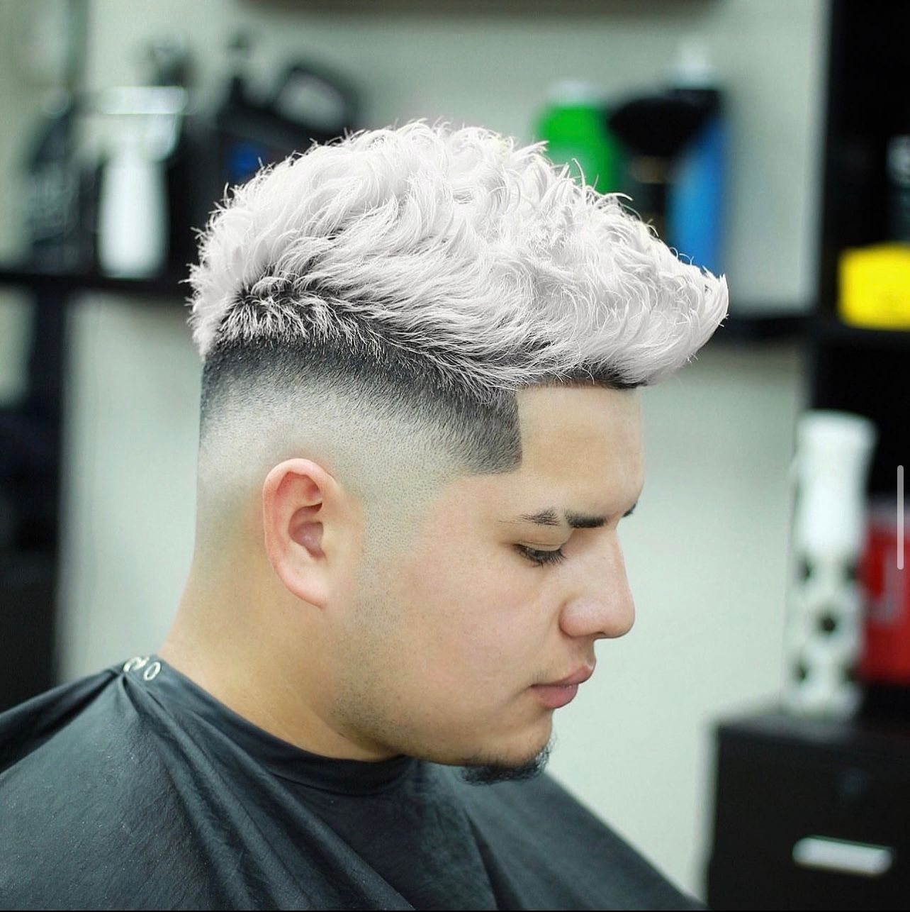 A man is getting his hair cut at a barber shop