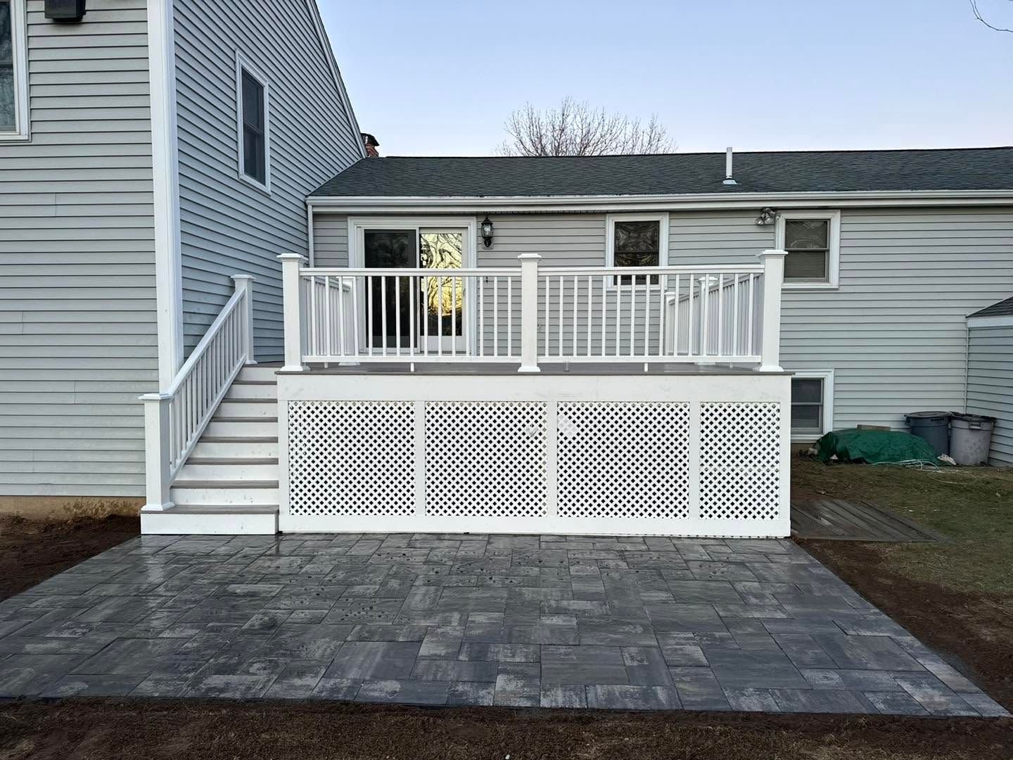 Two views of a wooden deck with white and red railings, benches, and a covered grill outdoors.