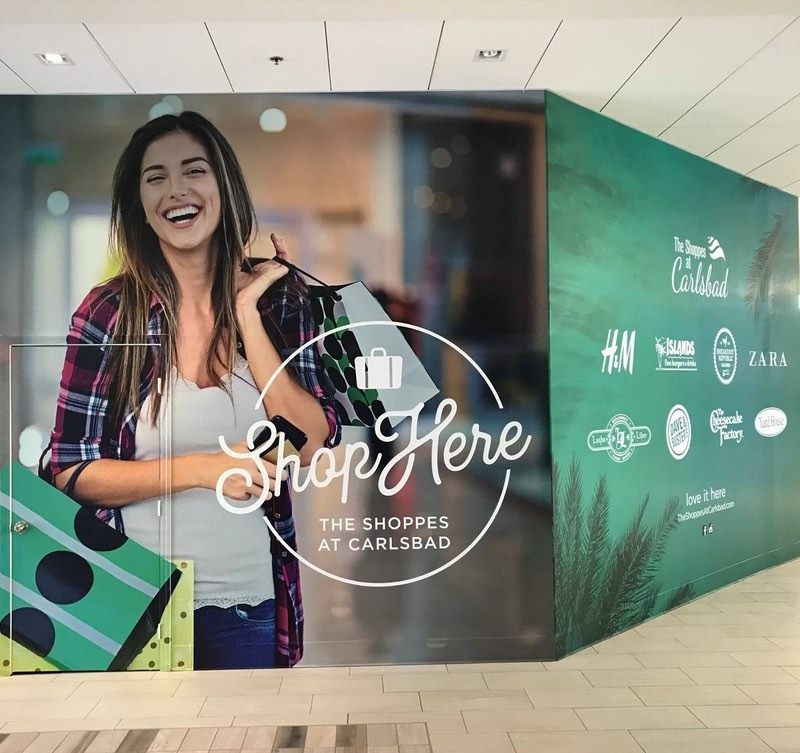 Woman with shopping bags smiling at 