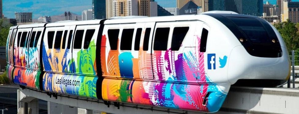Monorail train with colorful abstract design and Twitter logo. Las Vegas.
