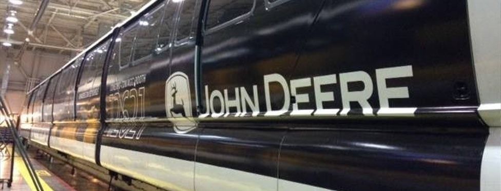 John Deere branded train, black and white color scheme, indoors.
