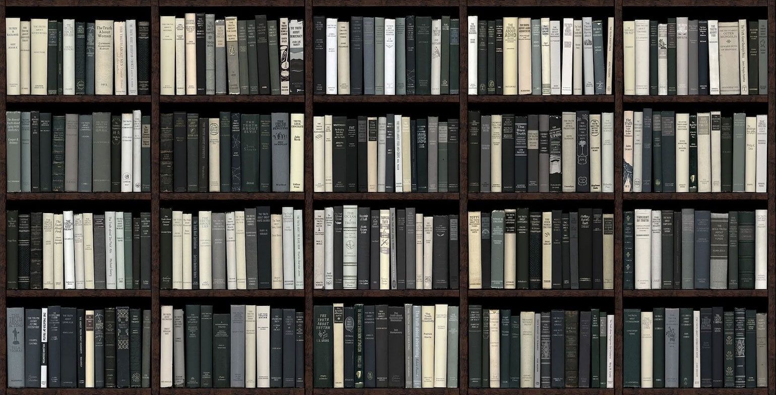 Bookshelves filled with rows of books in shades of gray and white.