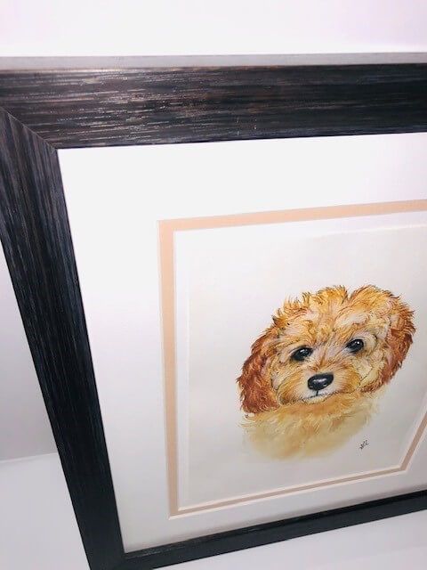 Watercolor painting of a fluffy golden-brown dog in a framed, matted presentation.