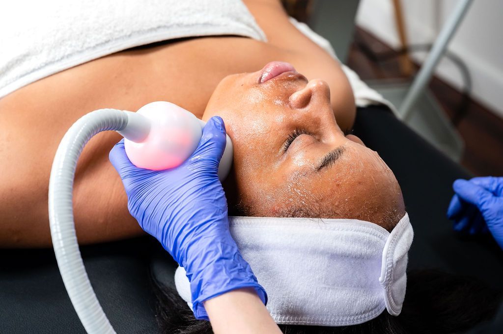 A woman is getting a facial treatment at a spa.