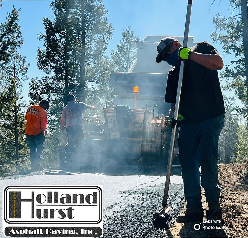 a holland hurst asphalt paving inc. logo on a road.