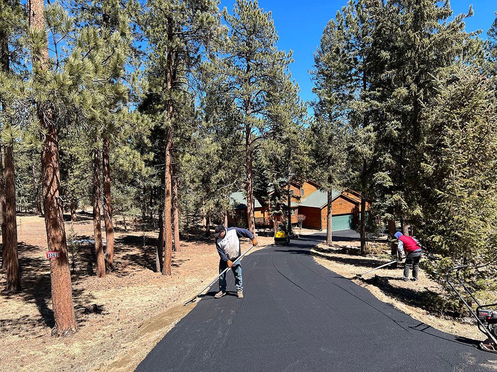 a man is standing on the side of a road with a broom.