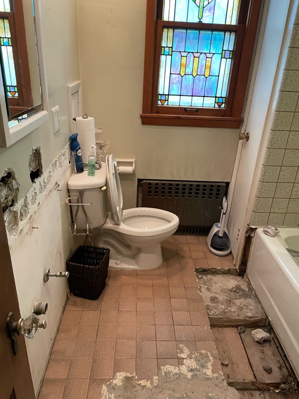 A bathroom with a toilet , sink , and bathtub.