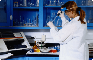 A chemist blending different chemicals