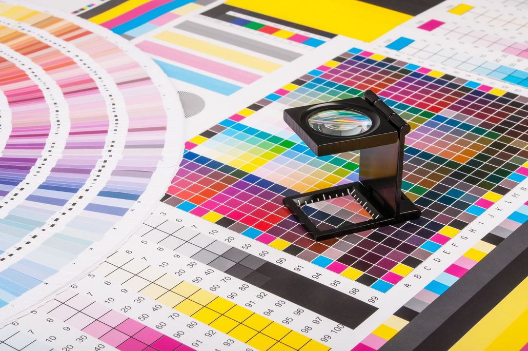 Color charts with a magnifying glass used for printing and color matching.