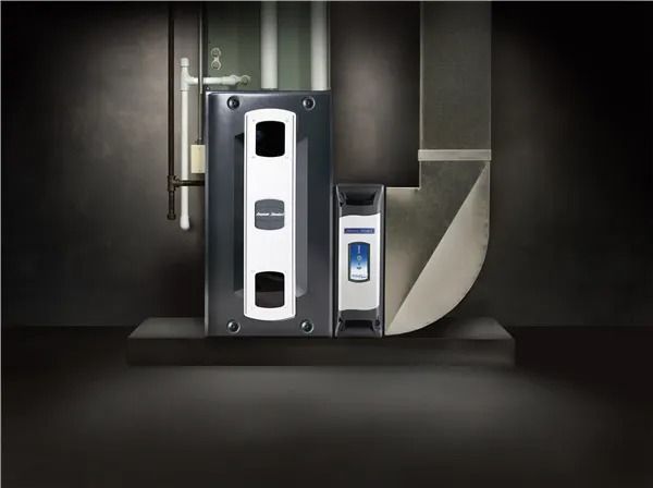 Two gray HVAC units with white panels, next to a duct, mounted on a platform against a dark wall.