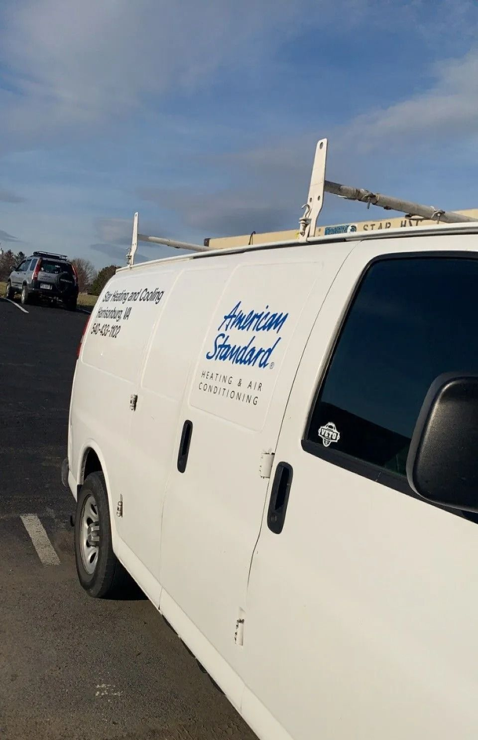 Girl and golden retriever smile at camera; woman rests on couch.