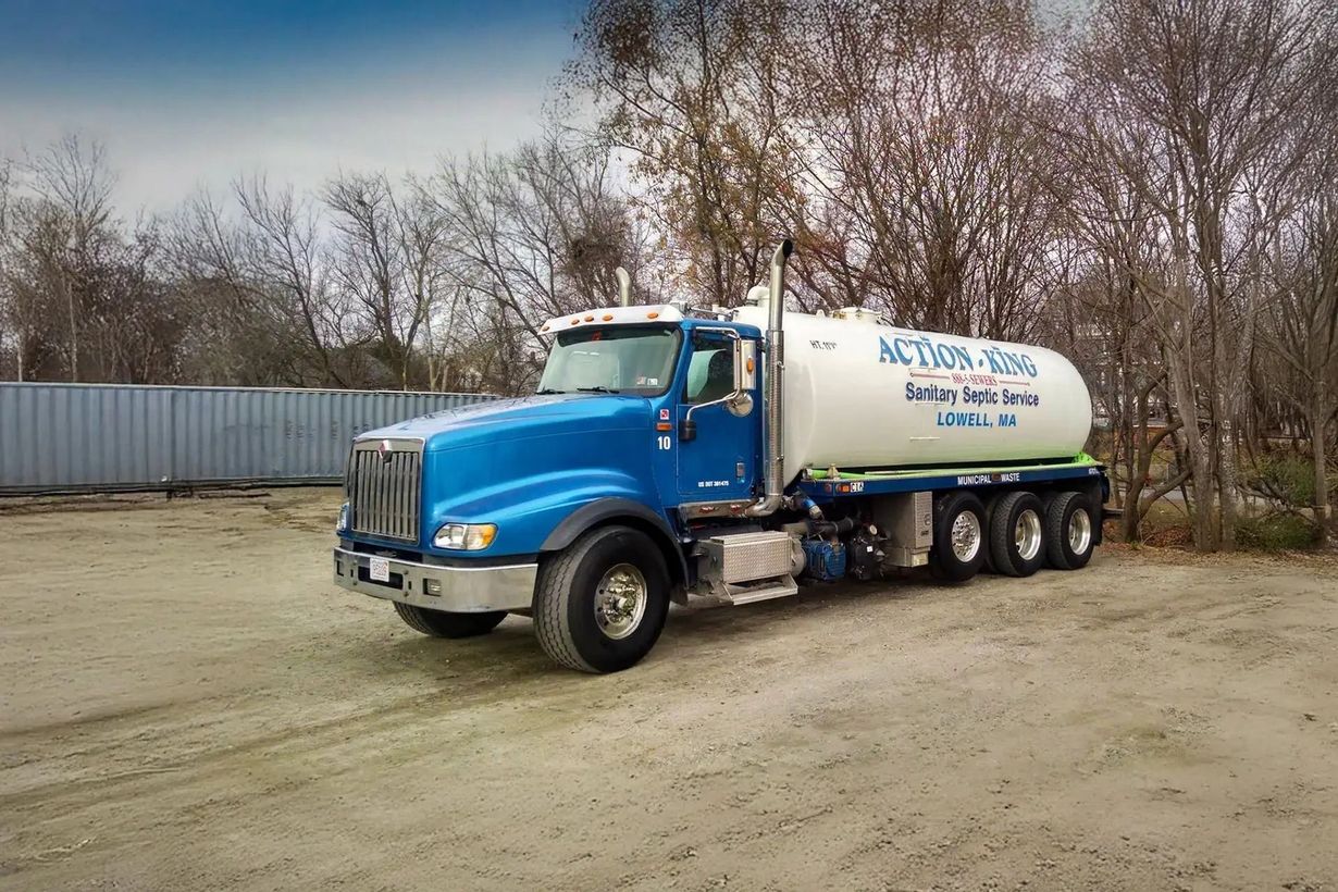 Blue tanker truck with white tank and company logo parked outdoors.