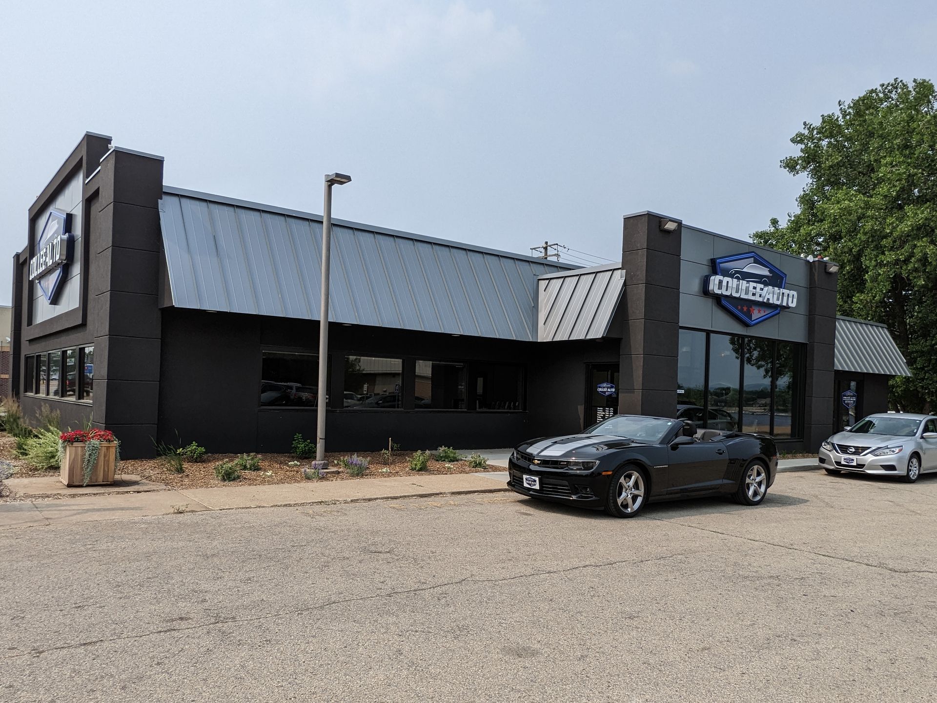 Coulee Auto storefront with parked cars