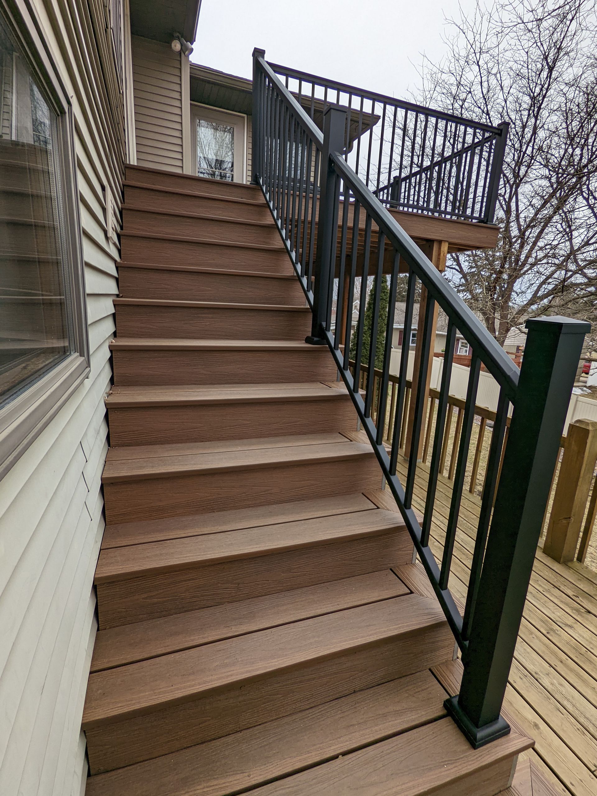 Wooden staircase with black railings