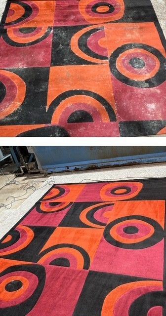 A red and black rug with circles on it