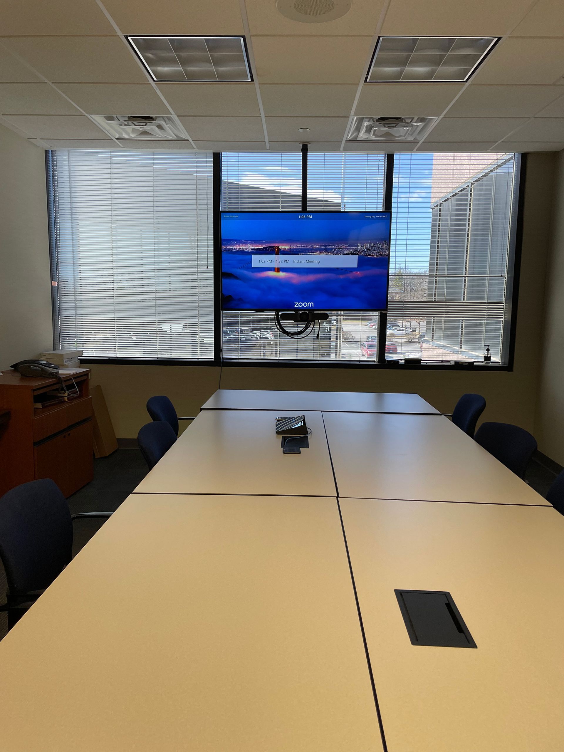 A conference room with a large screen on the wall