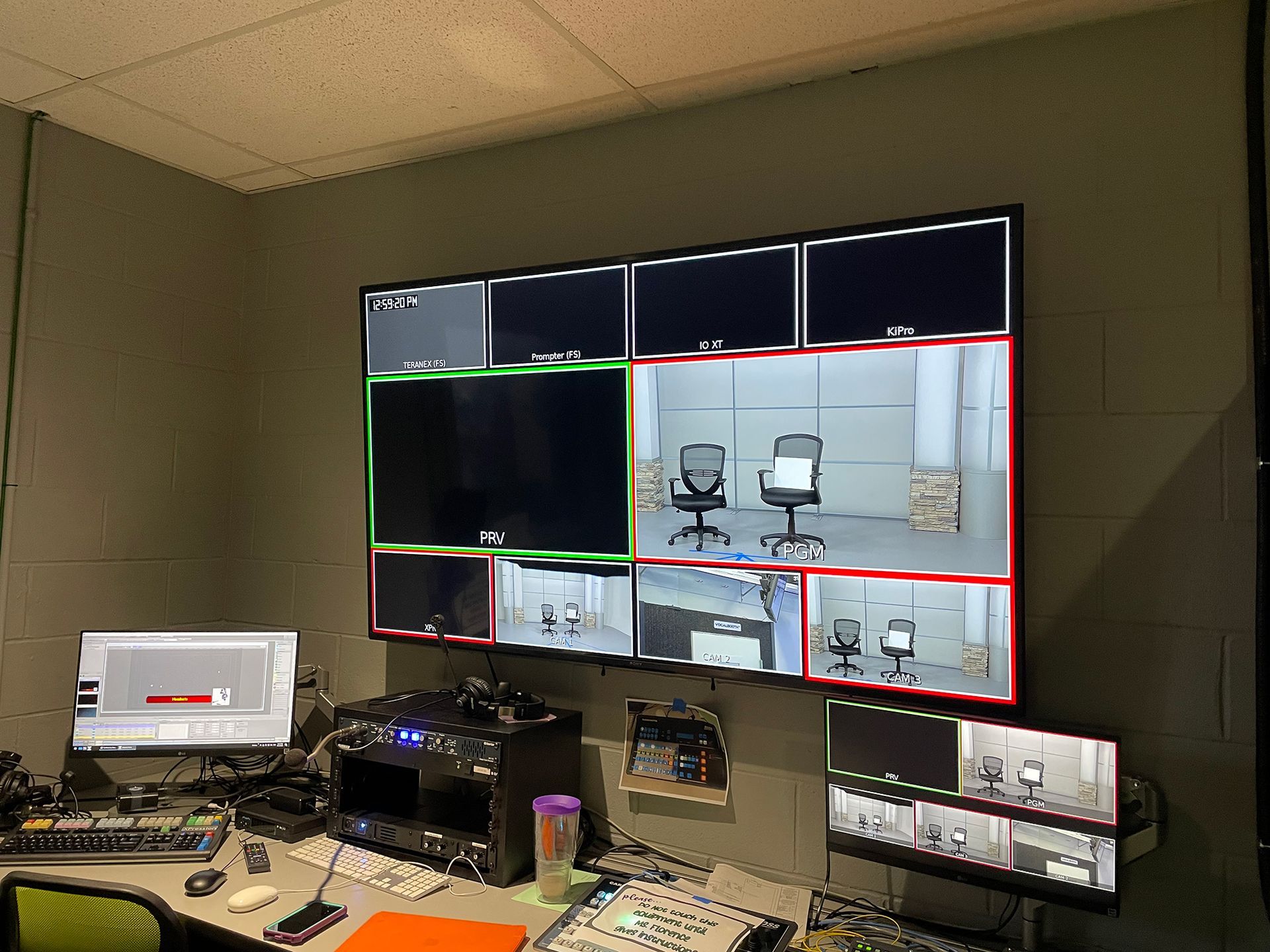 A room with a lot of monitors on the wall