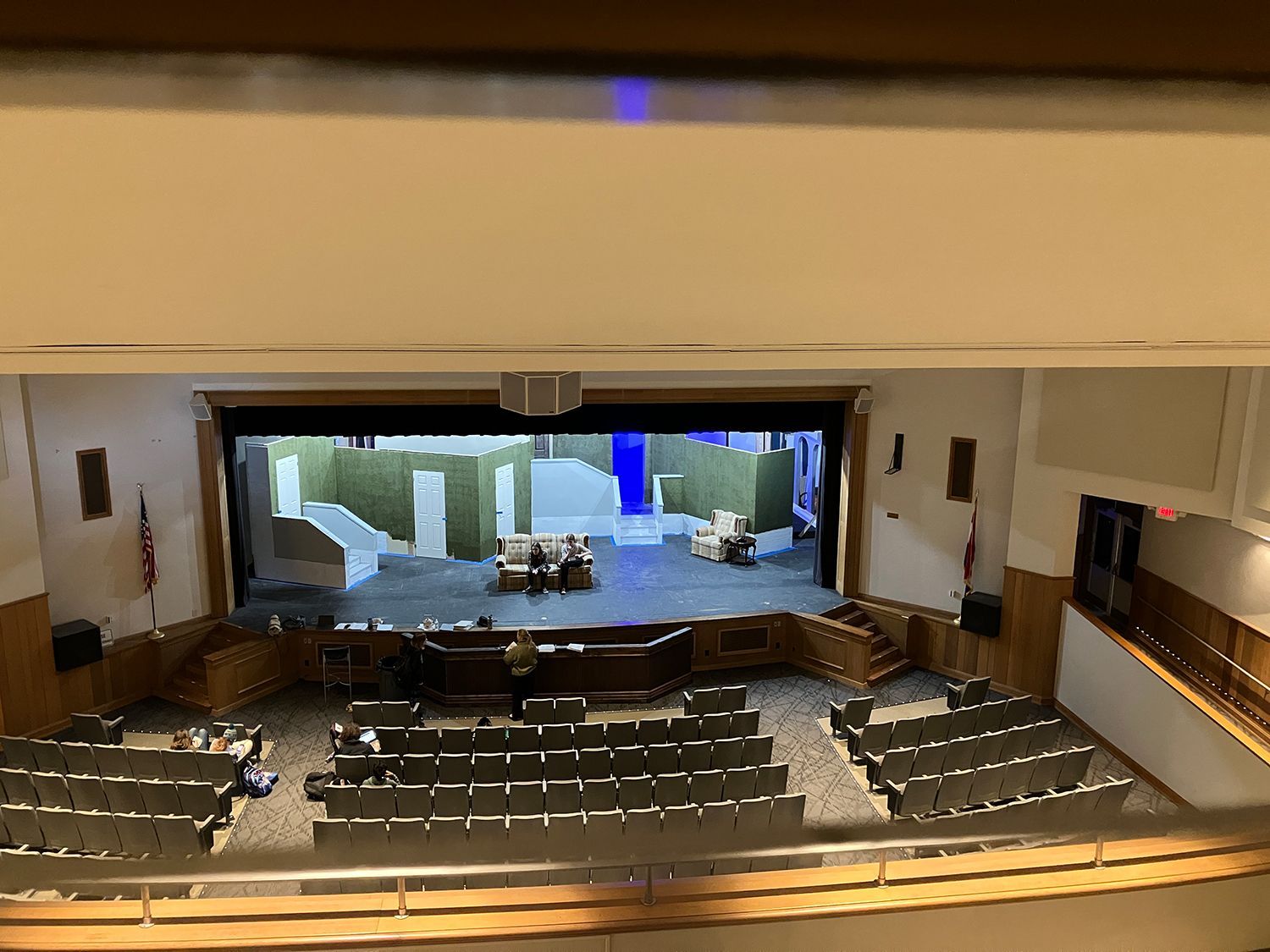 An aerial view of an auditorium with a large screen on the stage.