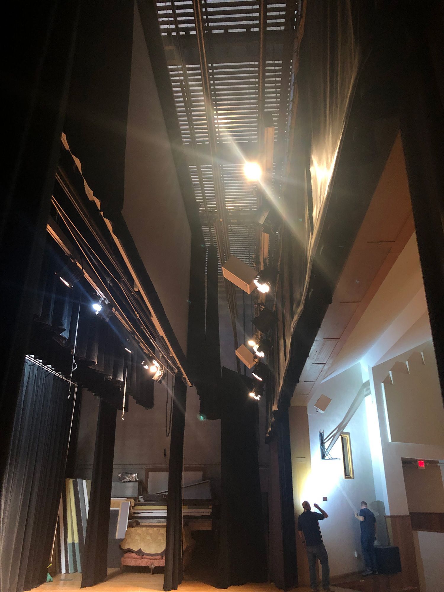 A man is standing in a dark room with a sign that says exit