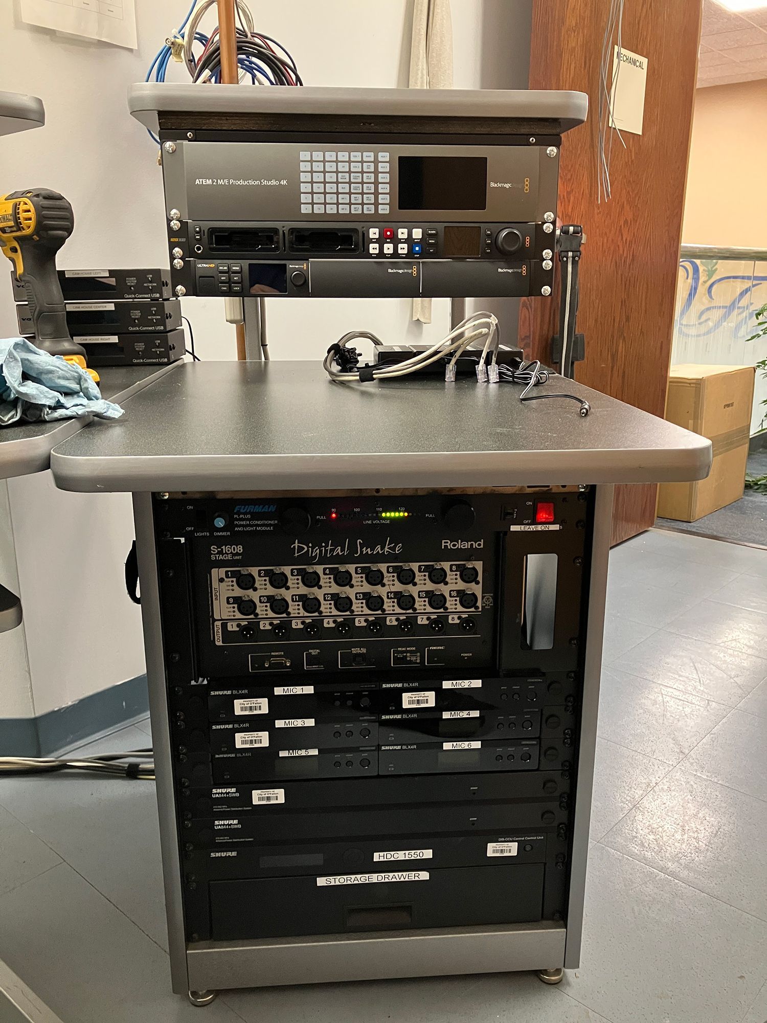 A stainless steel desk with a bunch of electronics on it