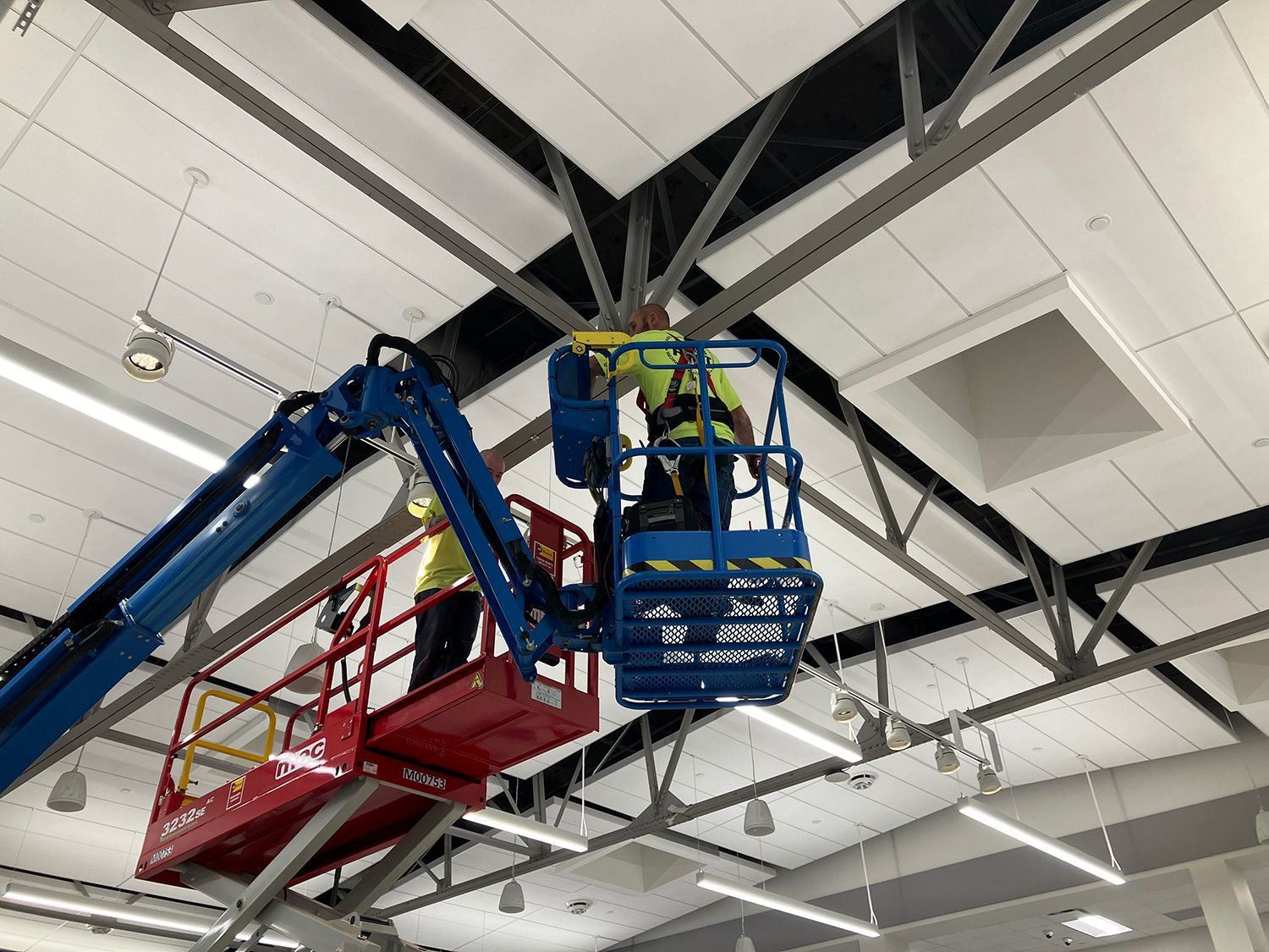 A man is working on a ceiling with a crane.