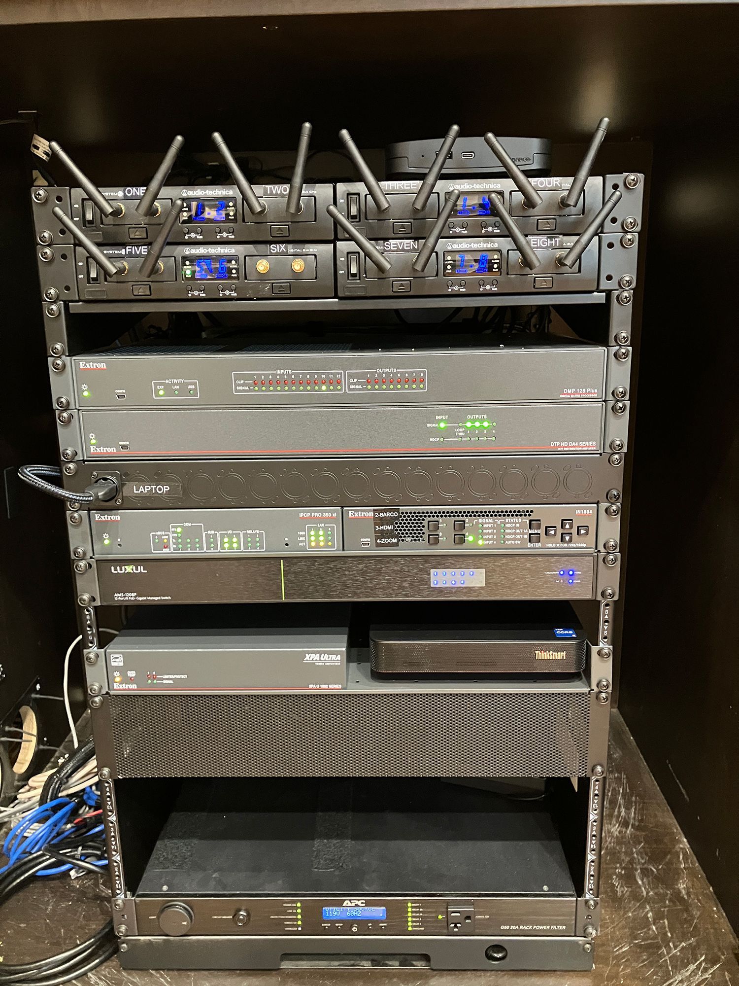 A stack of electronics sitting on top of each other on a shelf.