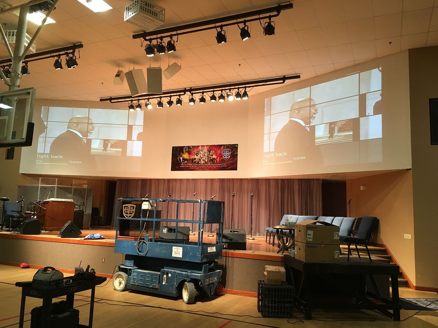 A large room with a projector screen on the wall