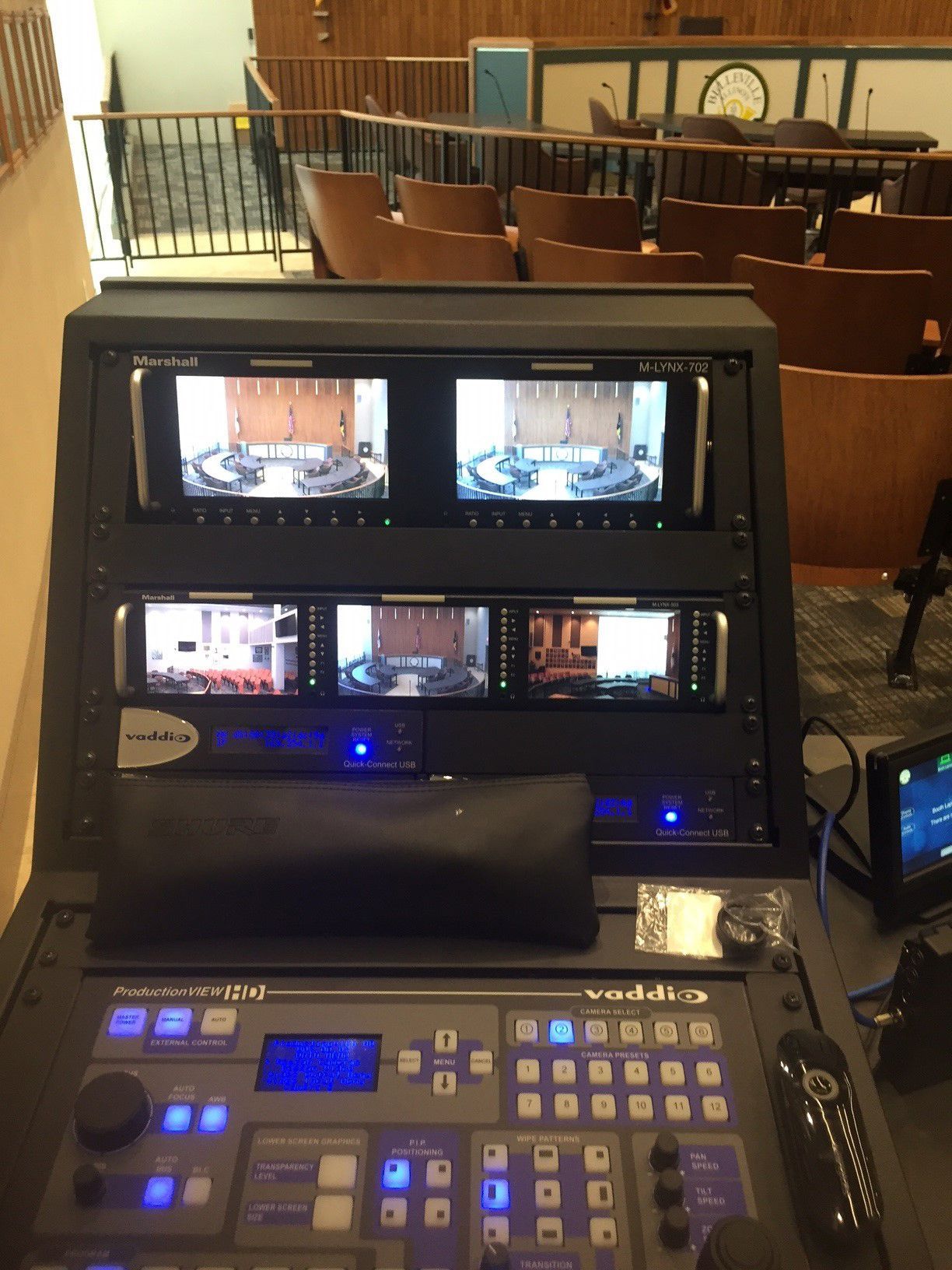 A panasonic control panel with two monitors on top of it