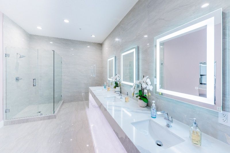 A bathroom with a row of sinks and mirrors.
