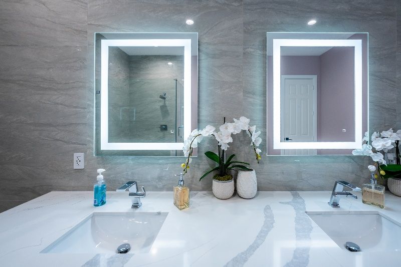 A bathroom with two sinks and two mirrors.