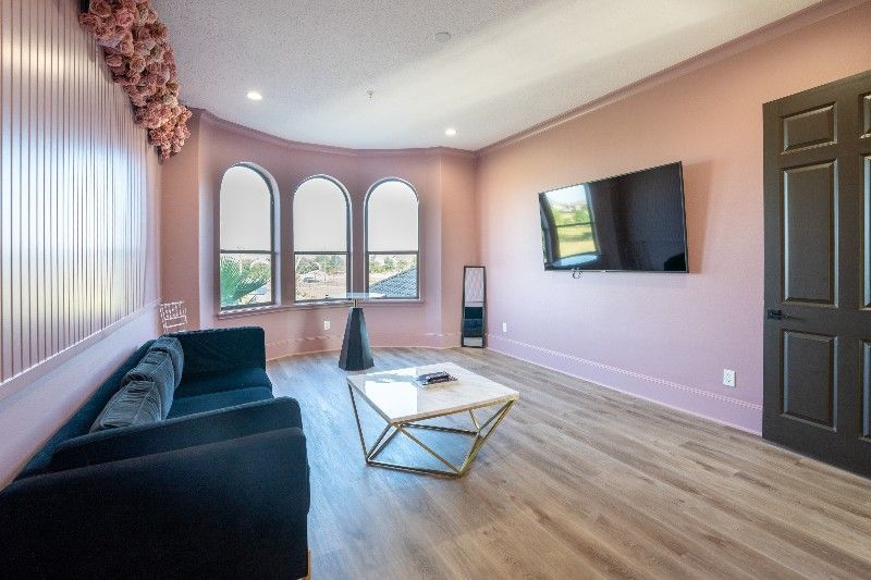 A living room with a couch , coffee table , and television.