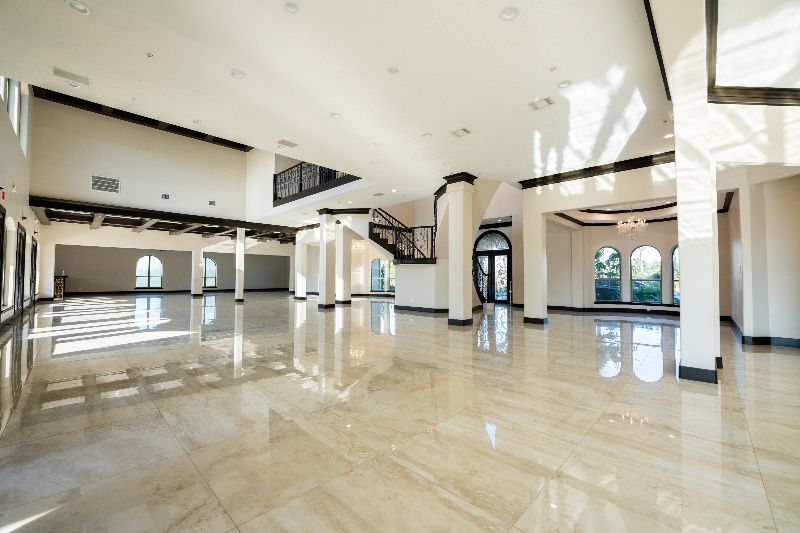 A large empty room with marble floors and white walls