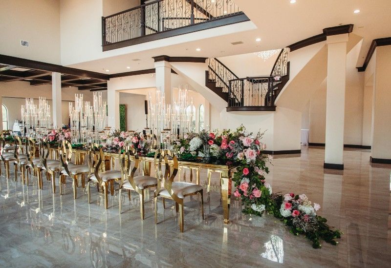 There is a table with flowers on it in the middle of the room.