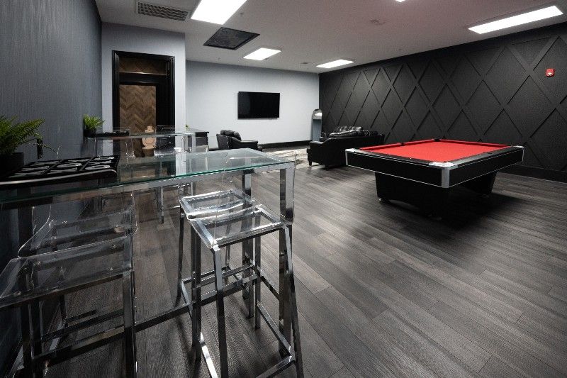 There is a pool table in the middle of the room.
