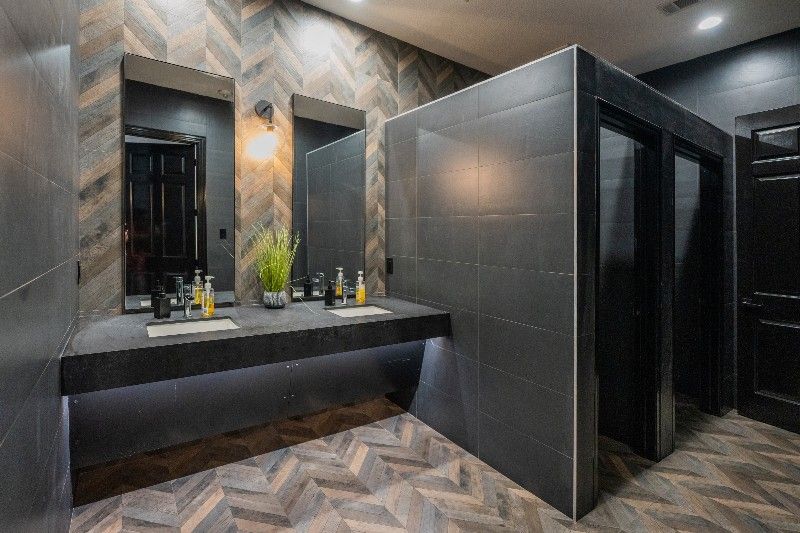 A bathroom with two sinks and two mirrors.