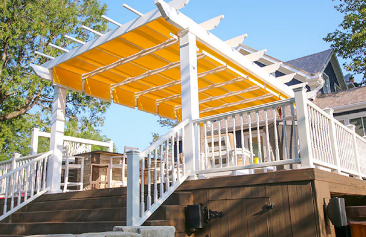 a deck with a yellow awning on top of it