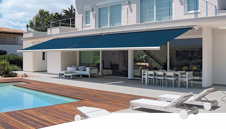 A large house with a swimming pool and a blue awning over it