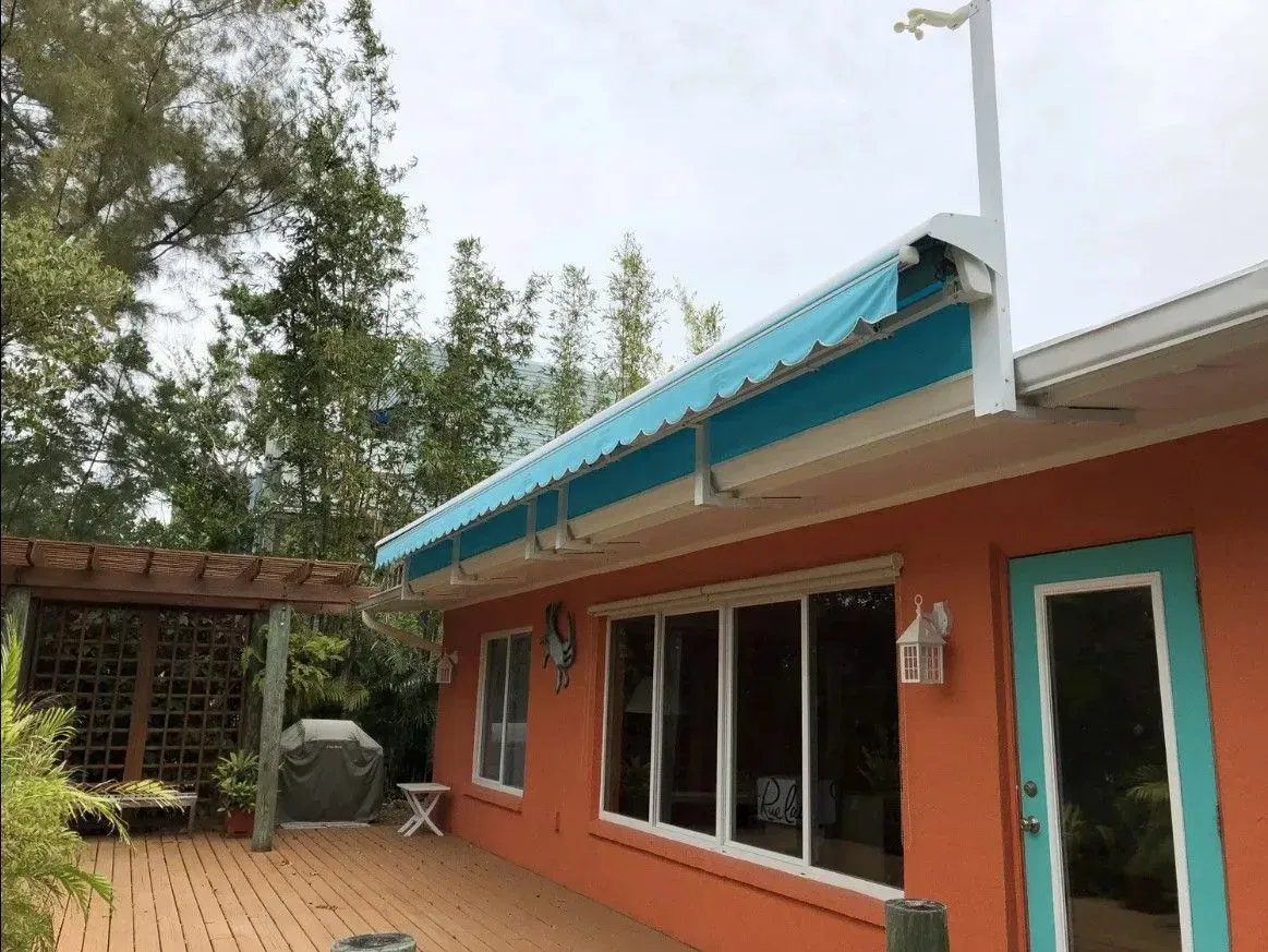 an orange house with a blue awning on the roof .