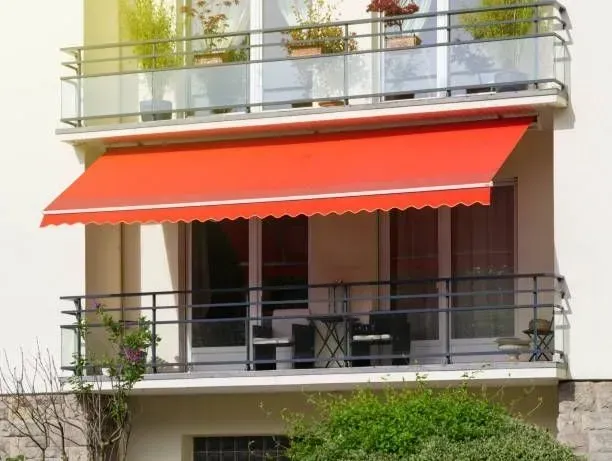 a balcony with a red awning over it