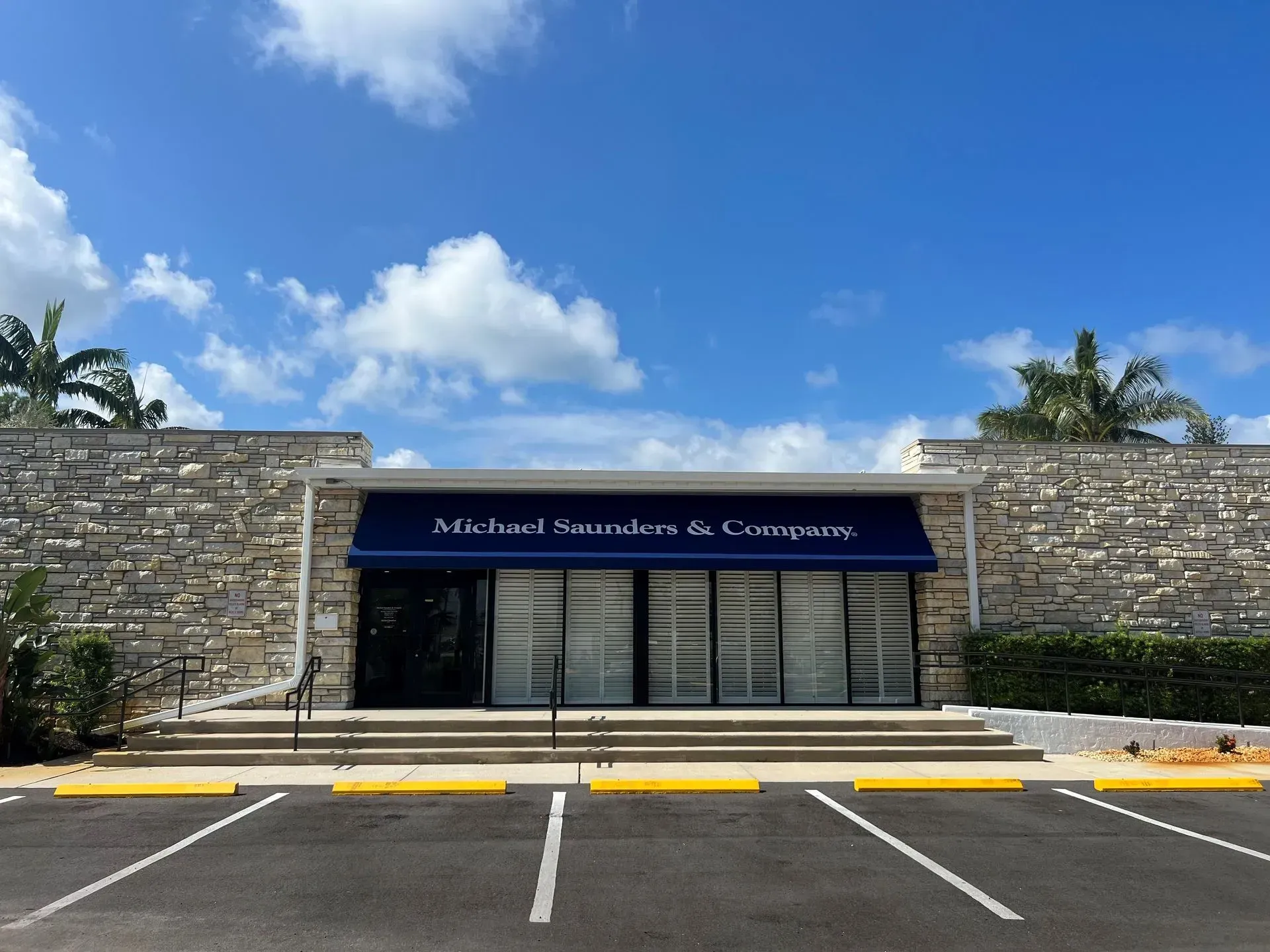 a building with a blue awning that says michael saturday